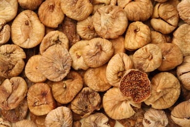 Photo of Many tasty dried figs as background, top view