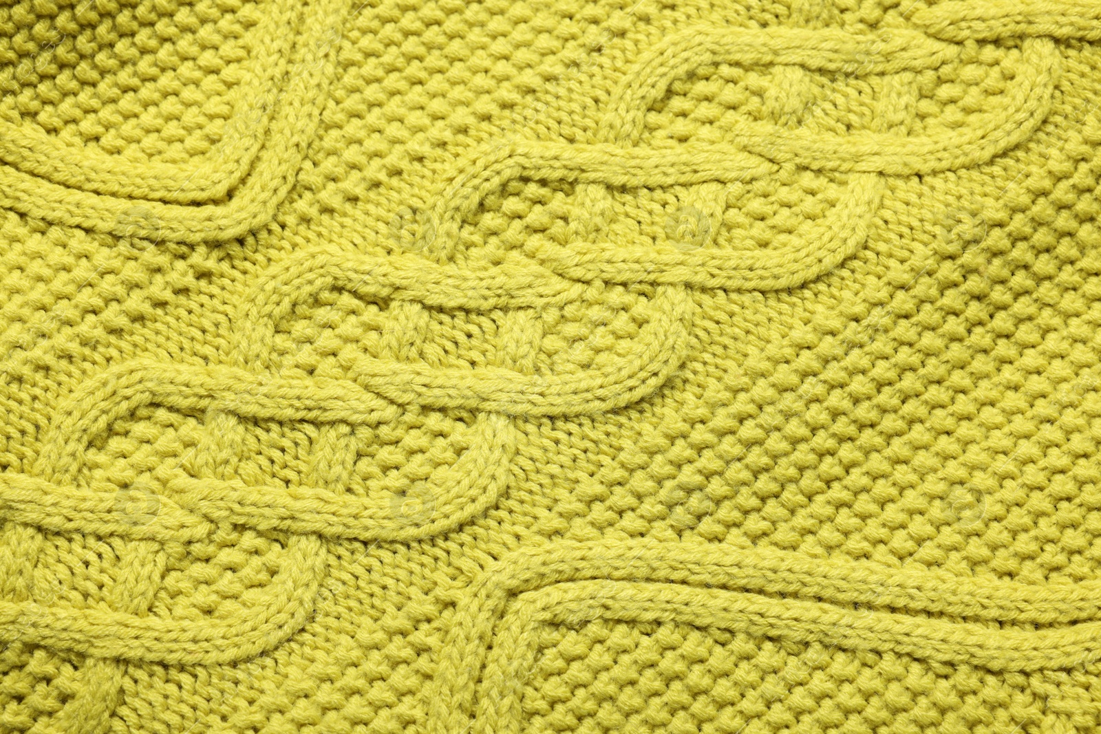 Photo of Texture of soft yellow fabric as background, top view