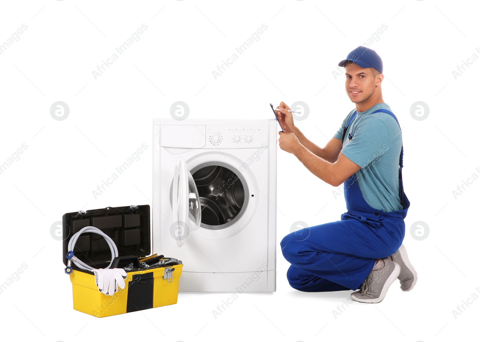 Photo of Repairman with clipboard and toolbox near washing machine on white background