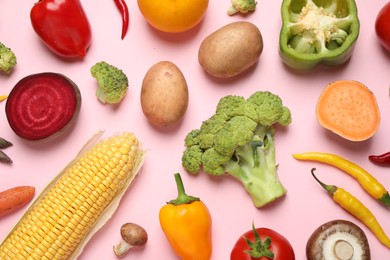 Photo of Flat lay composition with fresh vegetables on pink background