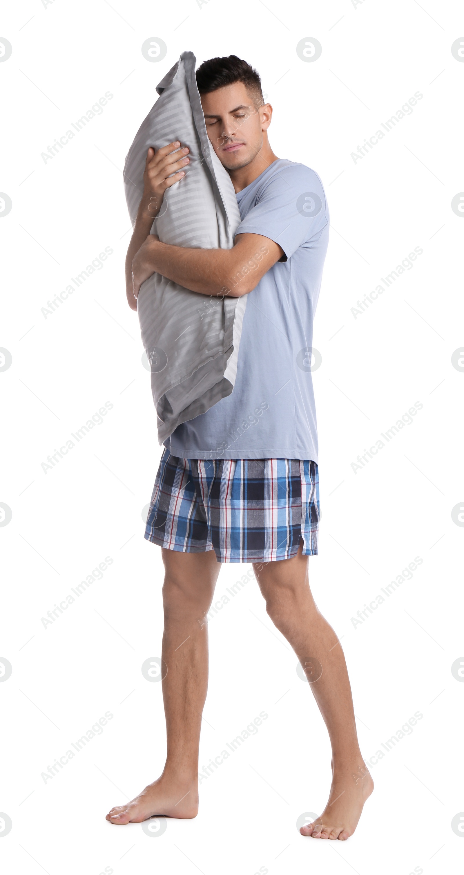 Photo of Somnambulist with soft pillow on white background. Sleepwalking