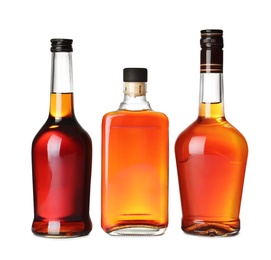 Photo of Bottles of scotch whiskey on white background