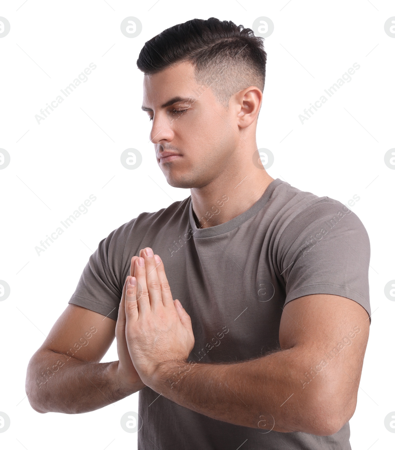 Photo of Handsome man meditating on white background. Harmony and zen