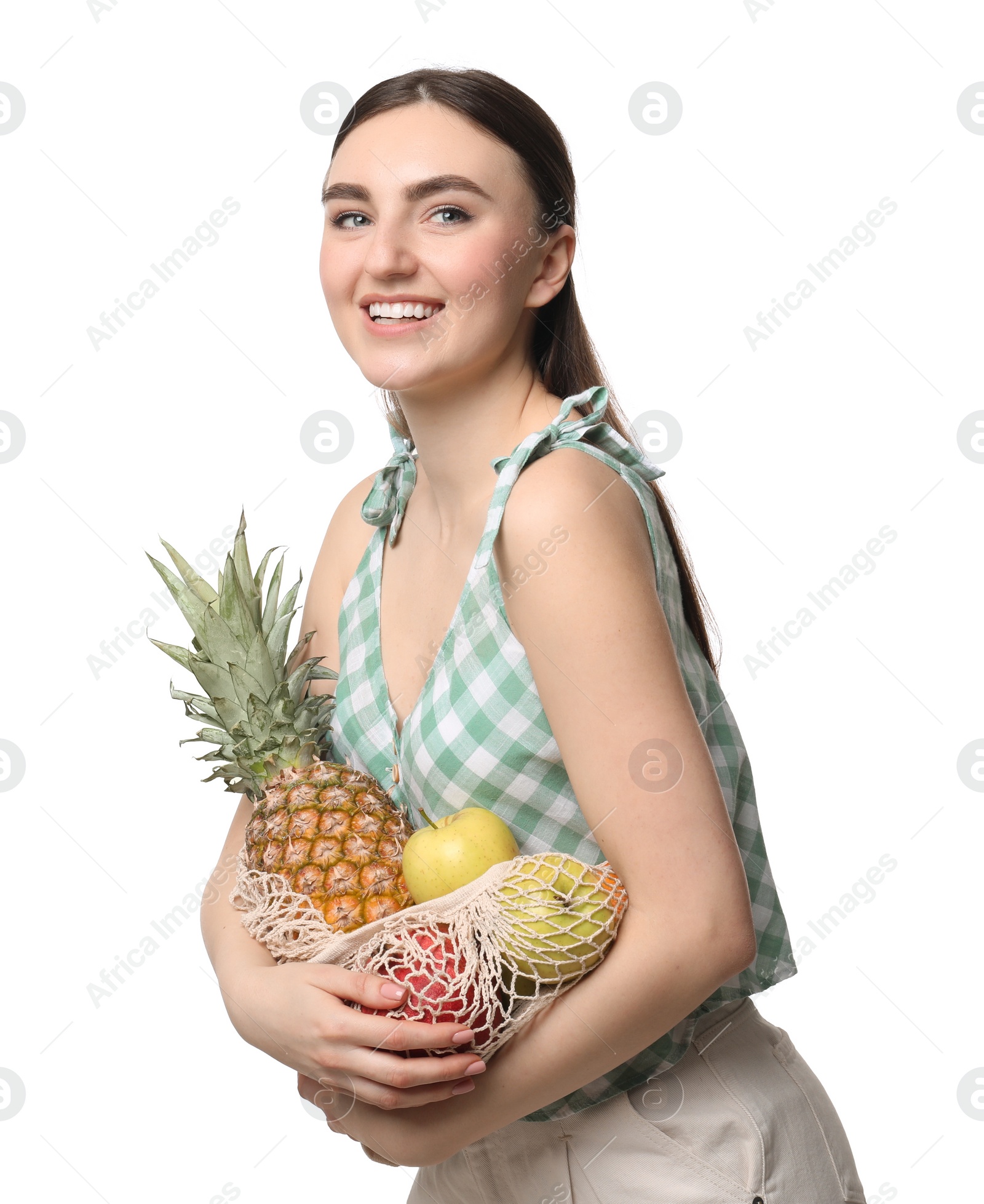 Photo of Woman with string bag of fresh fruits on white background
