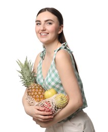 Photo of Woman with string bag of fresh fruits on white background