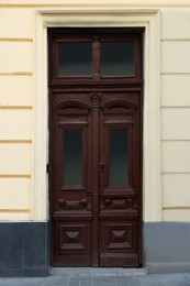Photo of Entrance of house with beautiful wooden door and transom window