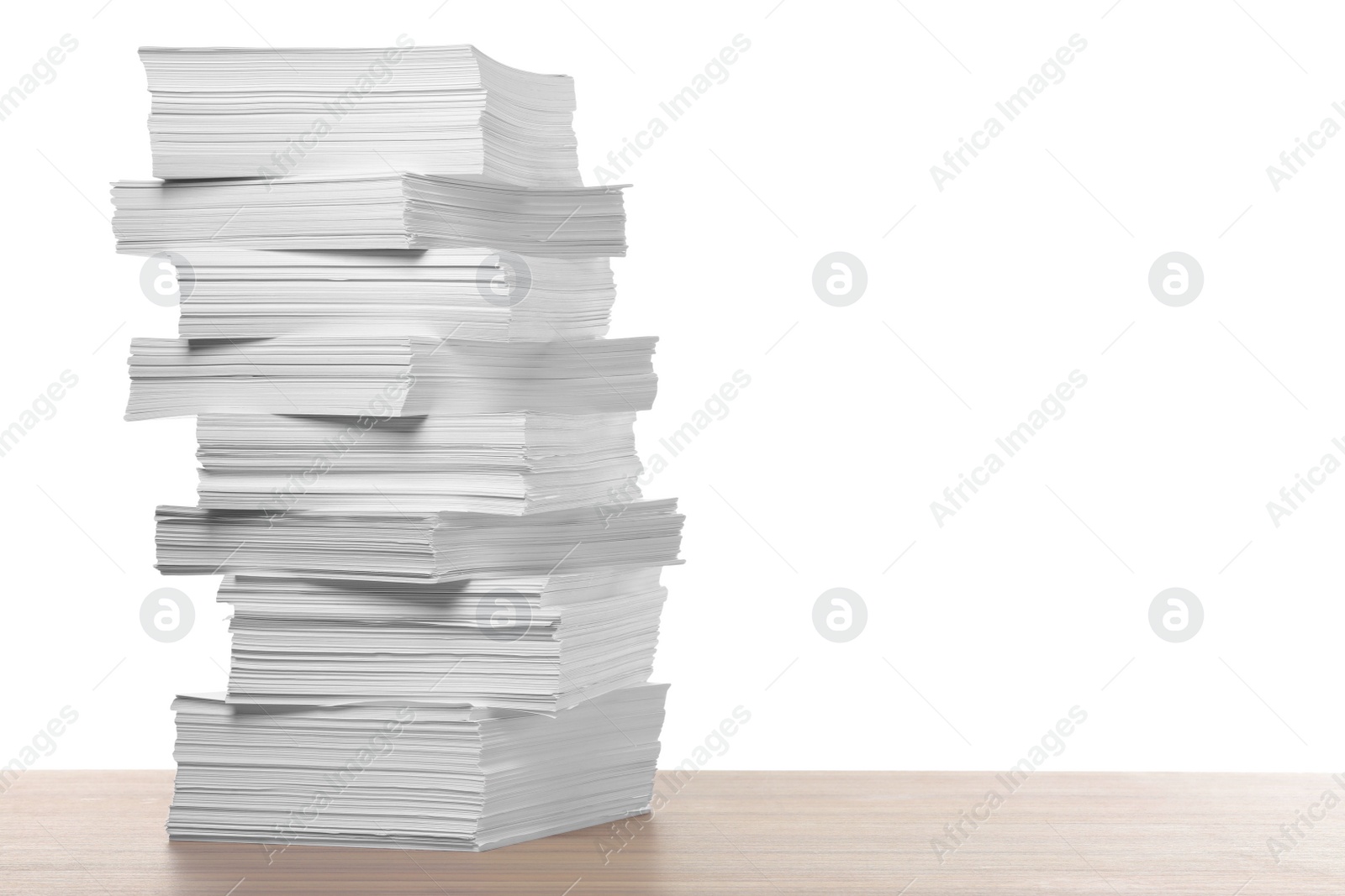 Photo of Stack of paper sheets on wooden table against white background. Space for text