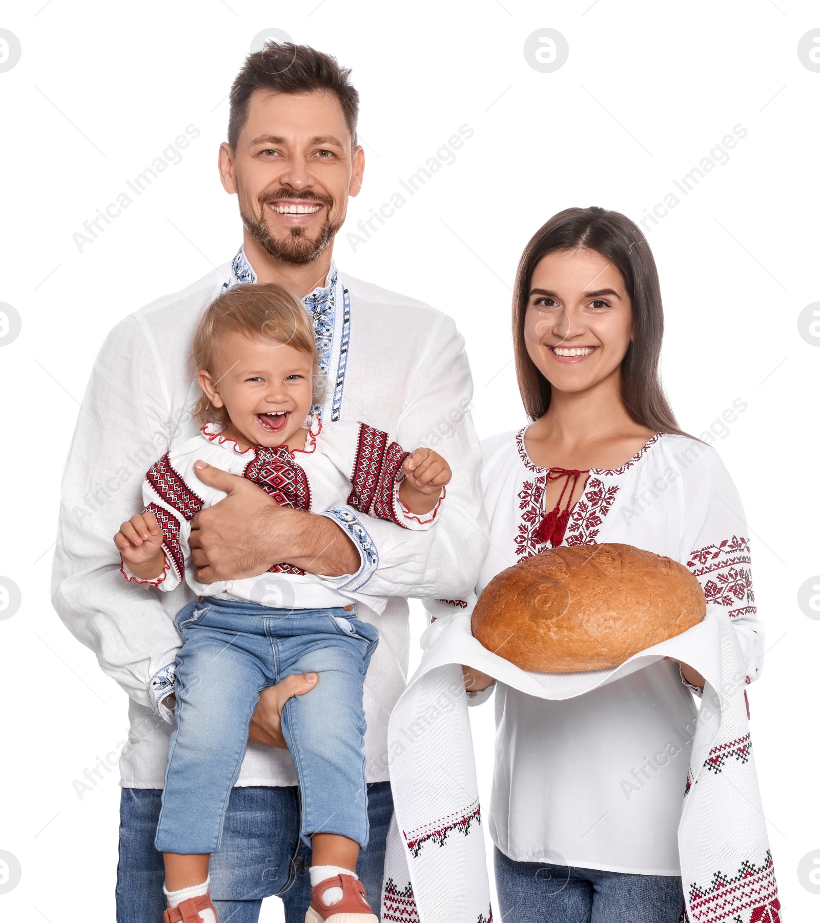 Photo of Happy Ukrainian family in embroidered shirts with korovai bread on white background