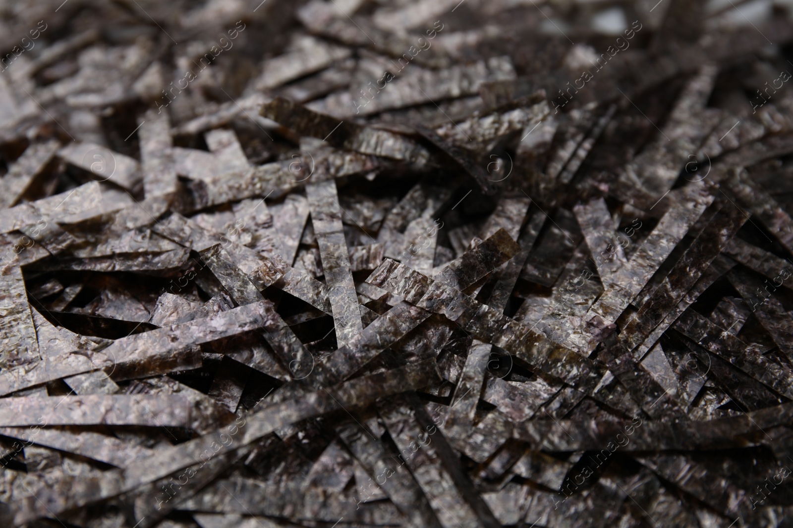 Photo of Chopped crispy nori sheets as background, closeup