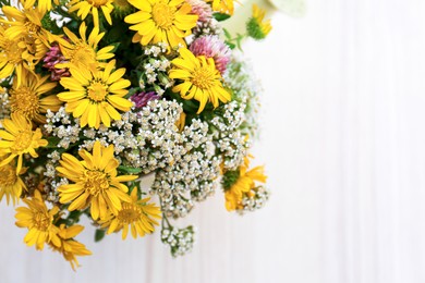 Photo of Beautiful bouquet of bright wildflowers in watering can on white wooden table, top view