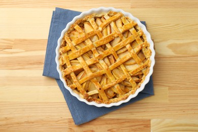 Photo of Tasty homemade quince pie on wooden table, top view