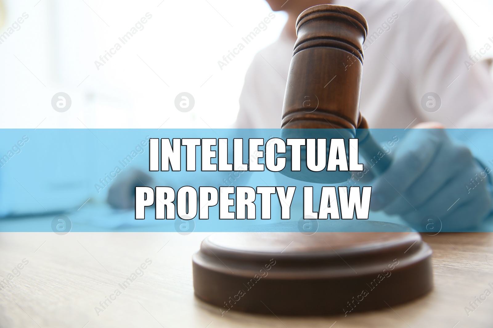 Image of Intellectual property law. Judge with gavel at table, closeup