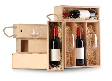 Photo of Wooden gift boxes with wine and glasses isolated on white