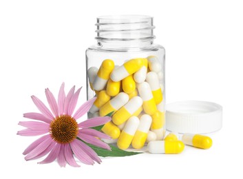Image of Bottle with vitamin pills and beautiful echinacea flower on white background
