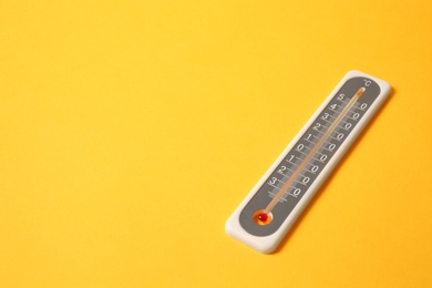Photo of Weather thermometer on yellow background. Space for text