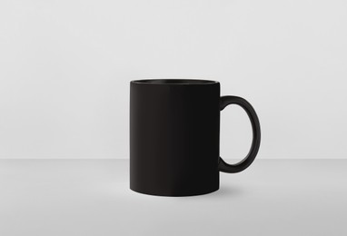 Black ceramic mug on white background. Mockup for design