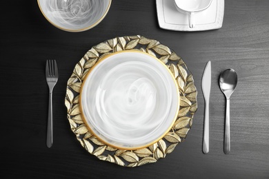 Elegant table setting on dark background, top view