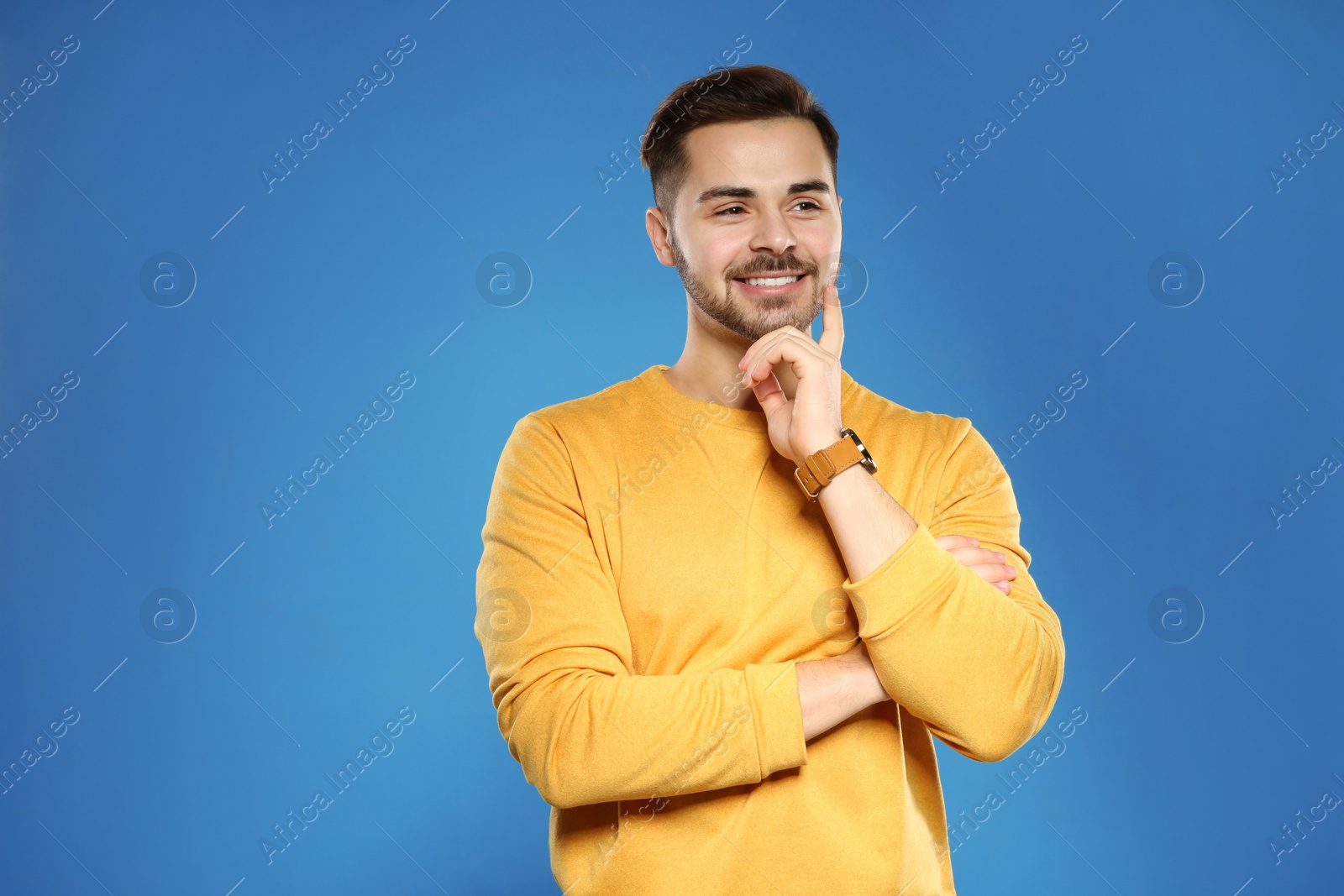 Photo of Portrait of handsome young man on color background