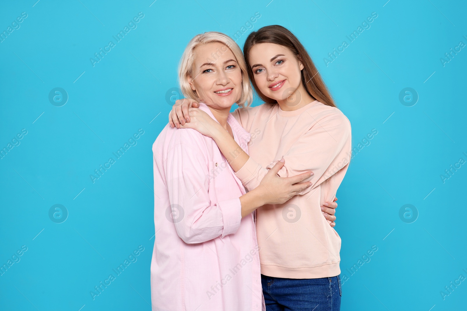 Photo of Portrait of mature woman and her daughter on color background