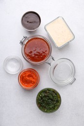 Photo of Different marinades on light table, flat lay