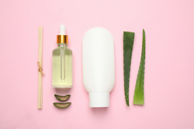 Flat lay composition with aloe vera and cosmetic products on pink background