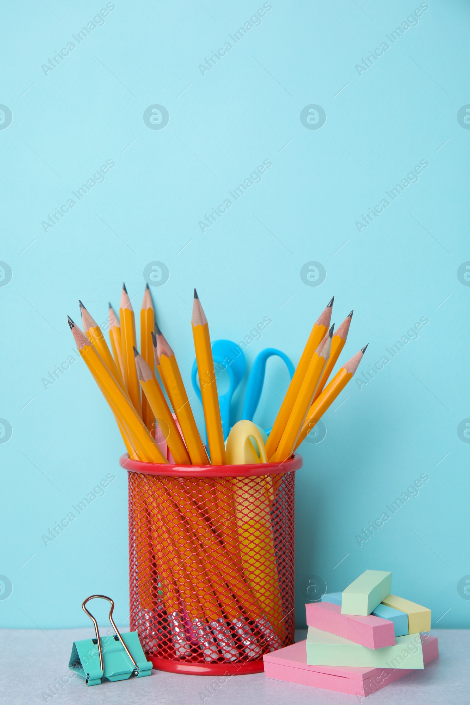 Photo of Different school stationery on table against light blue background. Back to school