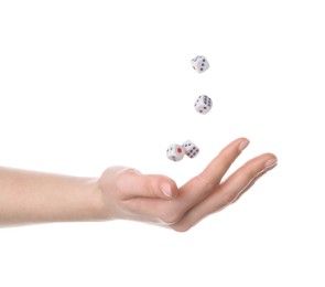 Photo of Woman throwing game dices on white background, closeup