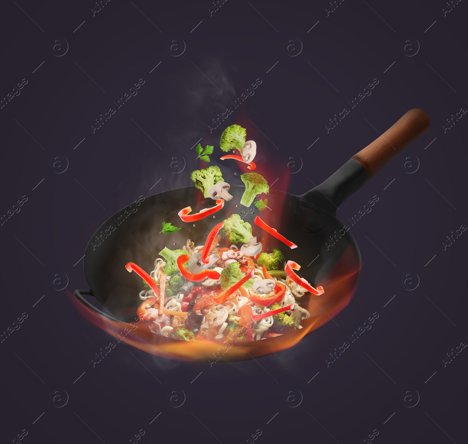 Image of Wok with tasty ingredients and fire on dark background