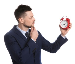 Businessman holding alarm clock on white background. Time management