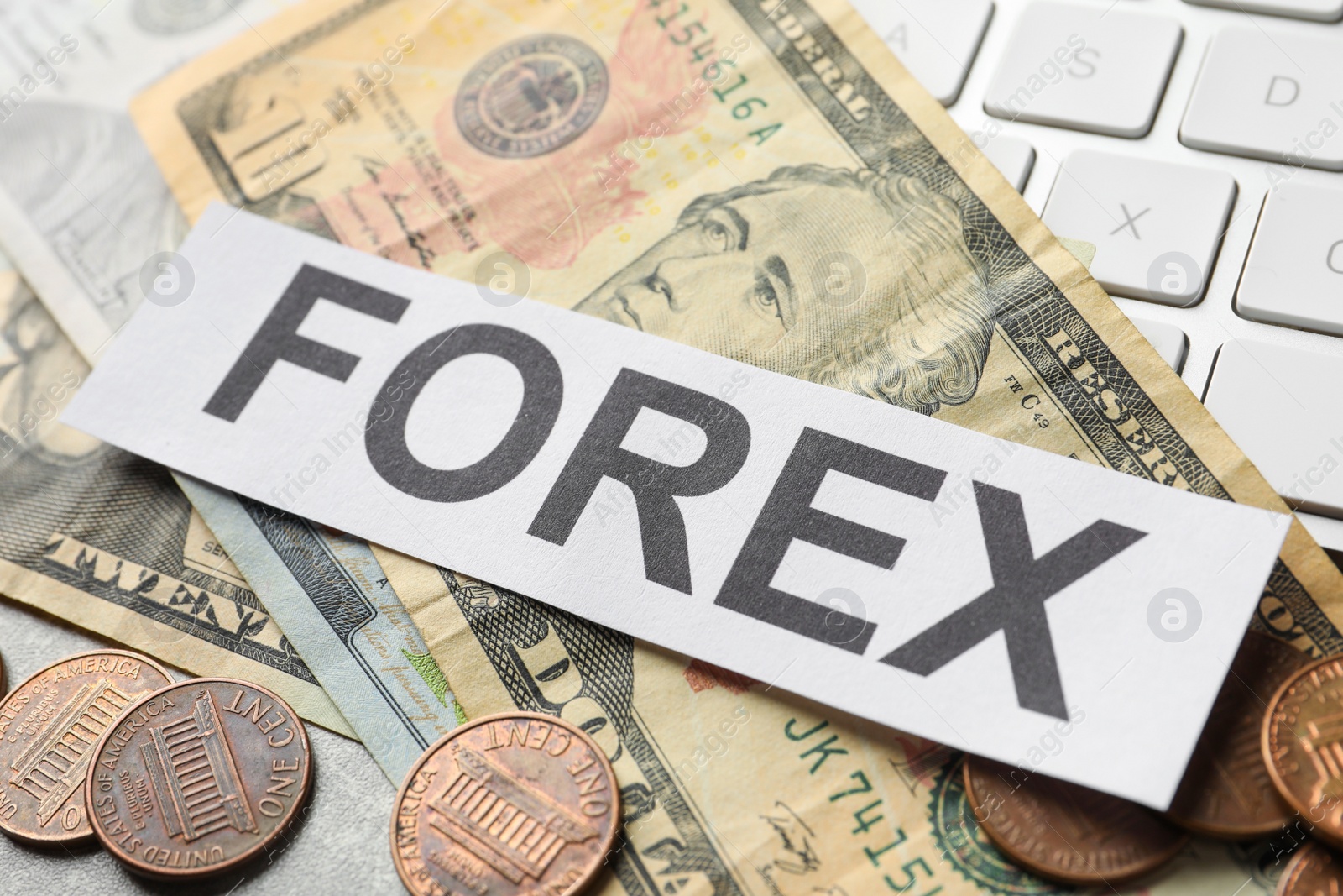 Photo of Sheet of paper with word Forex, coins and banknotes on grey table, closeup