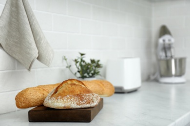 Fresh bread on countertop in modern kitchen. Space for text