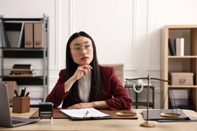 Portrait of notary at table in office