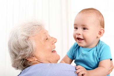 Cute little baby with grandmother at home