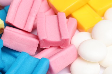 Different tasty colorful bubble gums as background, closeup