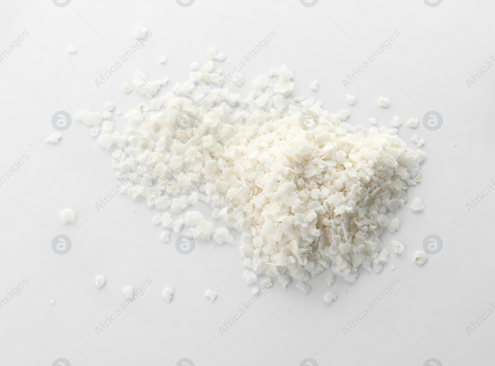 Photo of Raw rice flakes on white background. Healthy grains and cereals