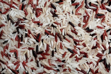 Mixed brown and other types of rice as background, closeup