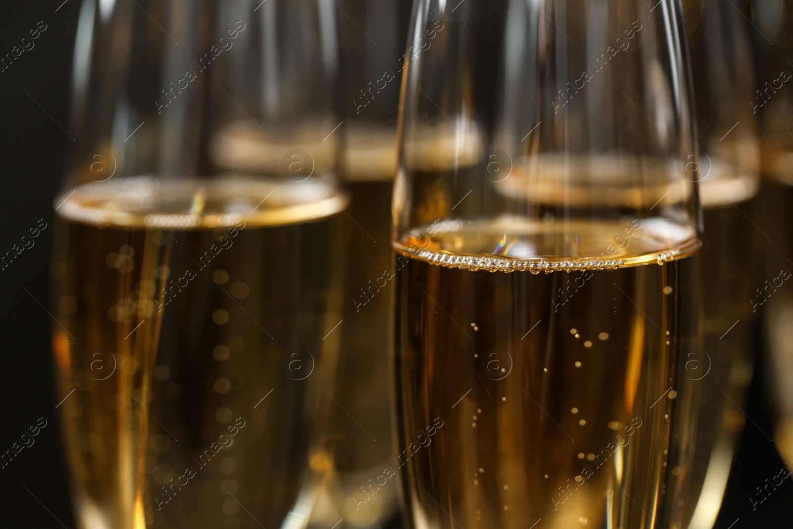 Photo of Many glasses of champagne as background, closeup view