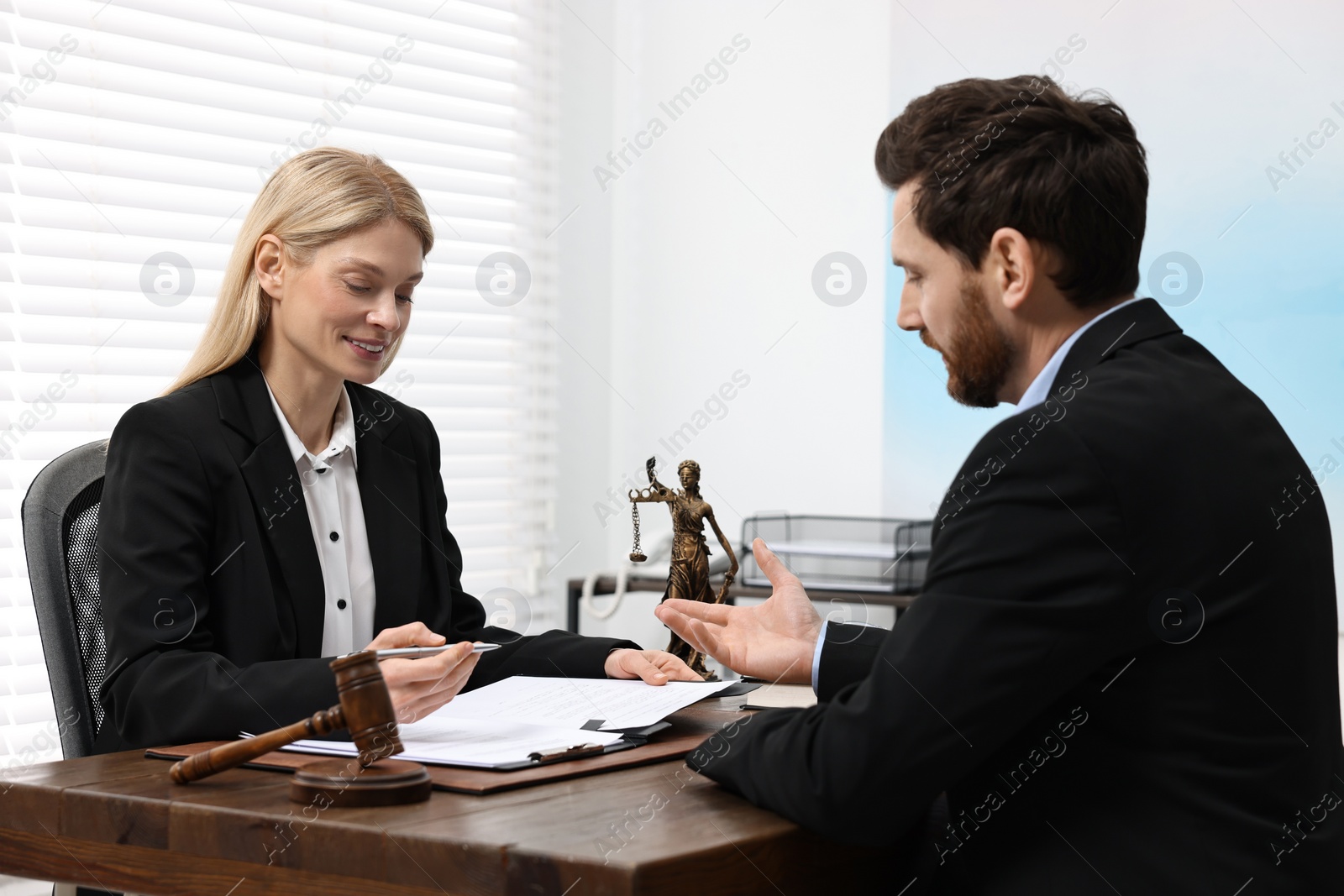 Photo of Man having meeting with lawyer in office