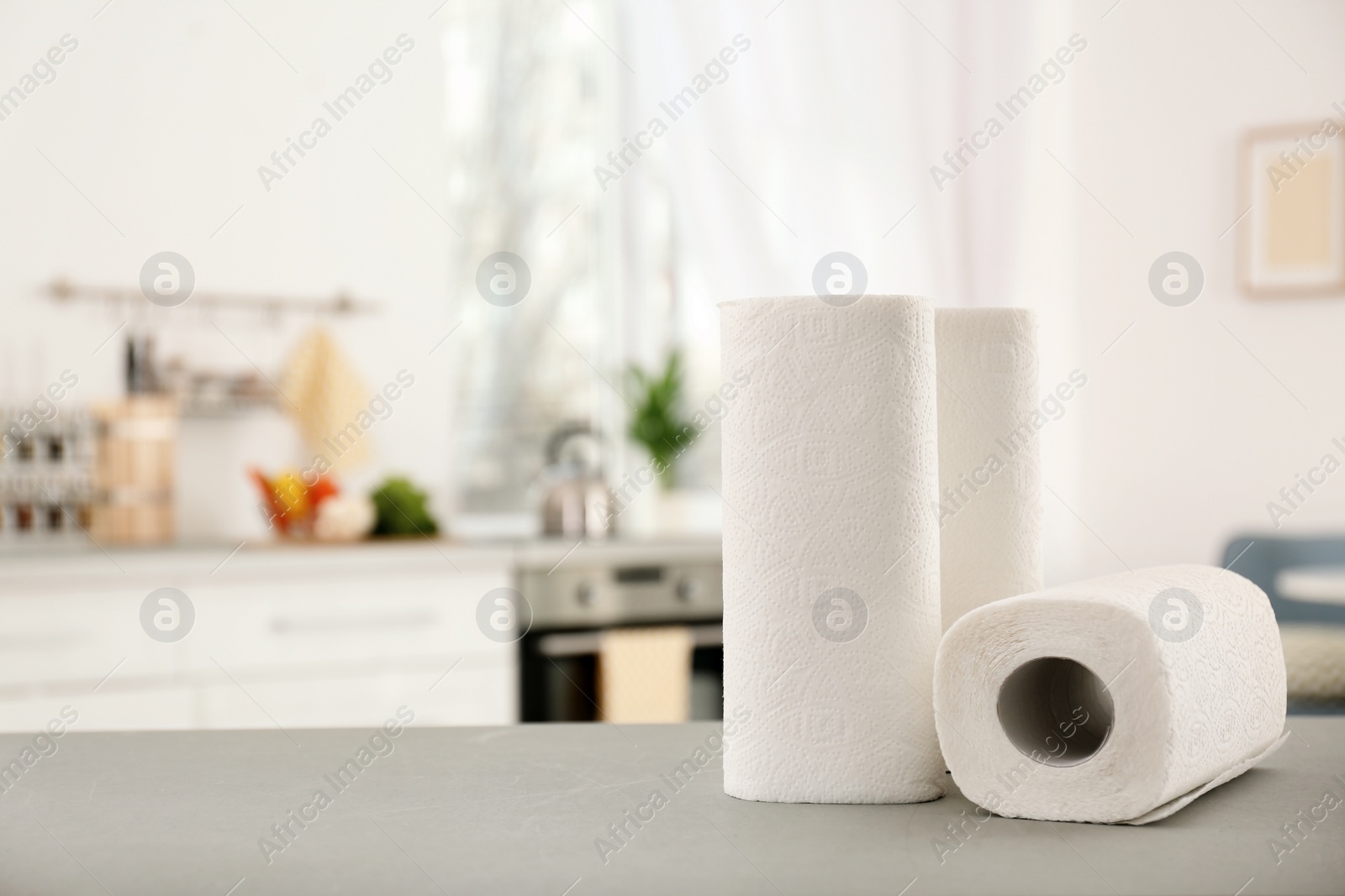 Photo of Rolls of paper towels on table in kitchen