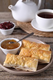 Photo of Delicious puff pastry served on wooden table