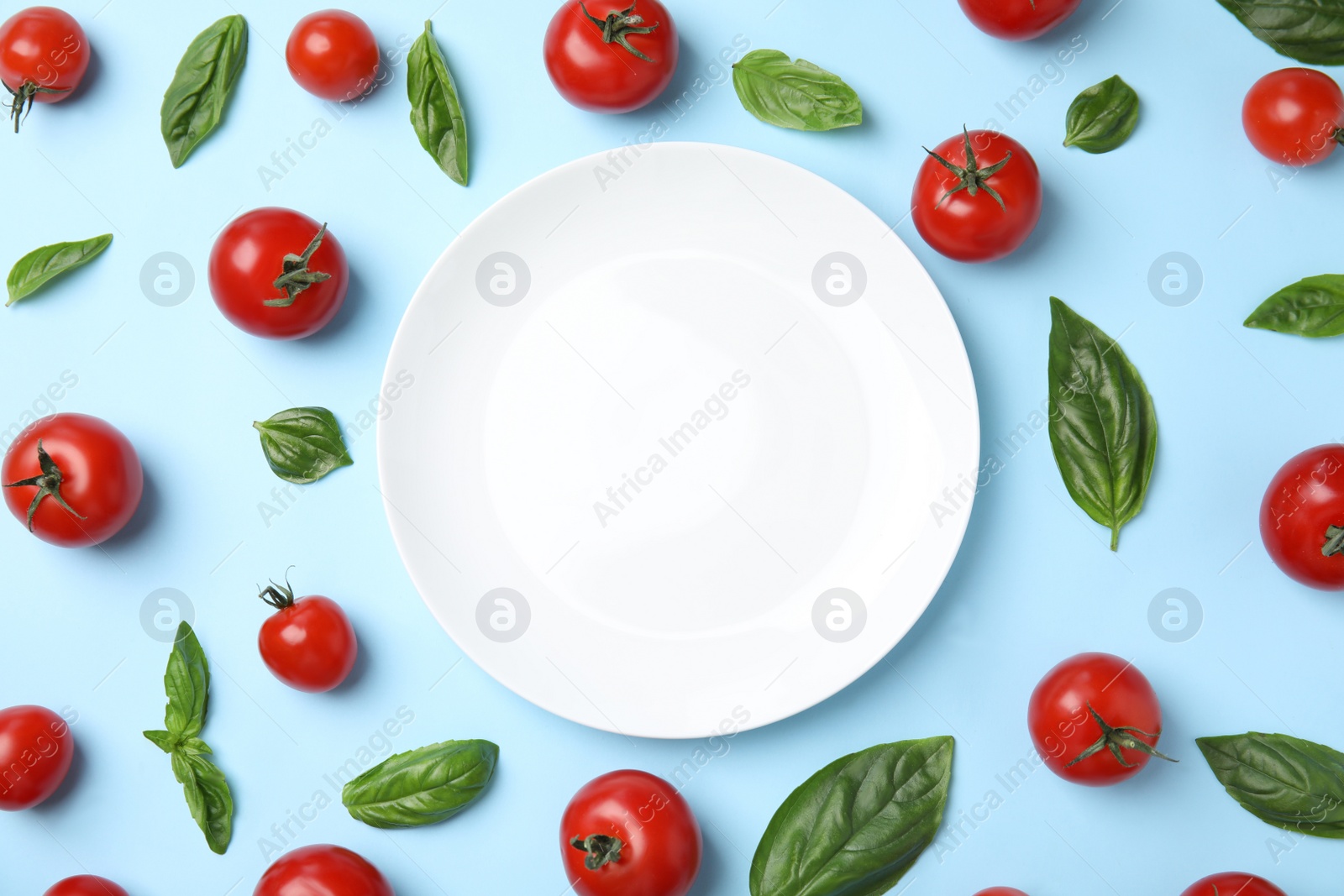 Photo of Flat lay composition with fresh salad ingredients on light blue background, space for text