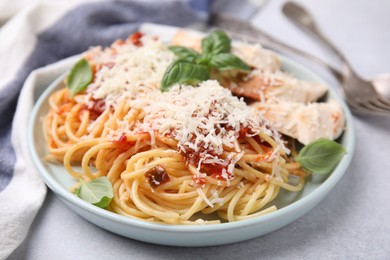 Photo of Delicious pasta with tomato sauce, chicken and parmesan cheese on white table, closeup