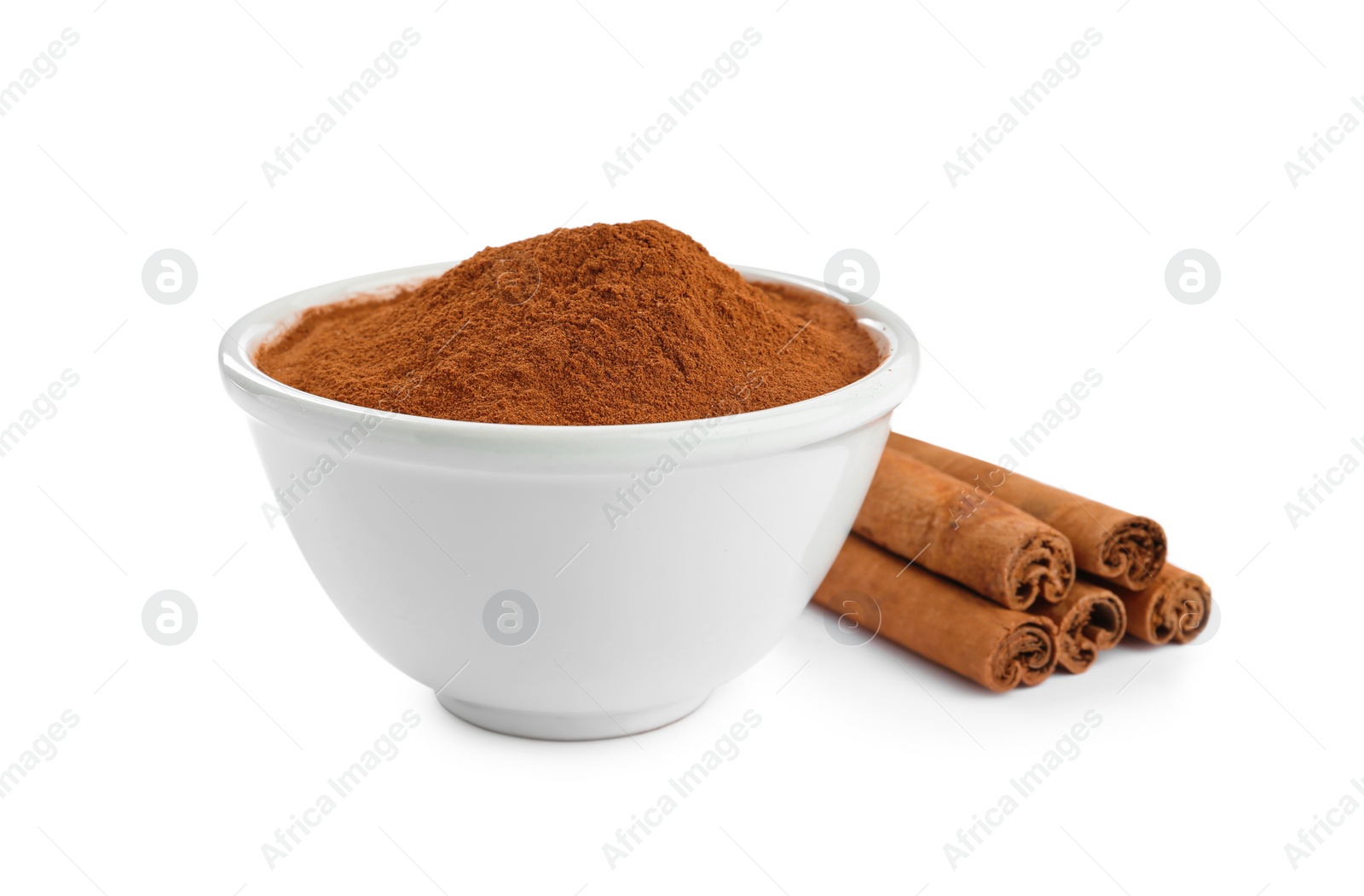 Photo of Aromatic cinnamon sticks and bowl with powder on white background