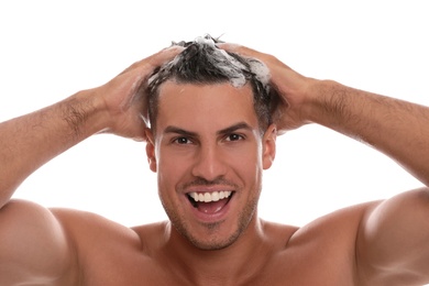 Photo of Handsome man washing hair on white background, closeup