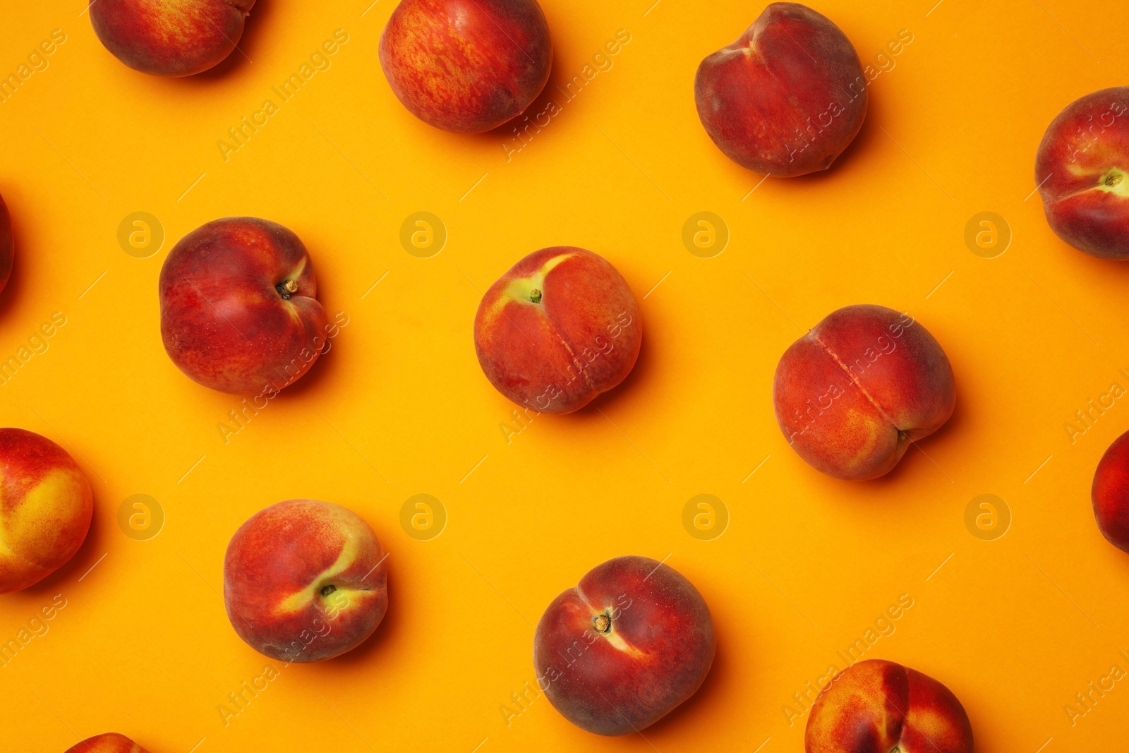 Photo of Flat lay composition with ripe peaches on orange background