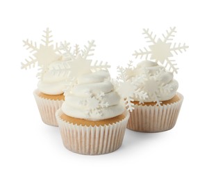 Tasty Christmas cupcakes with snowflakes on white background