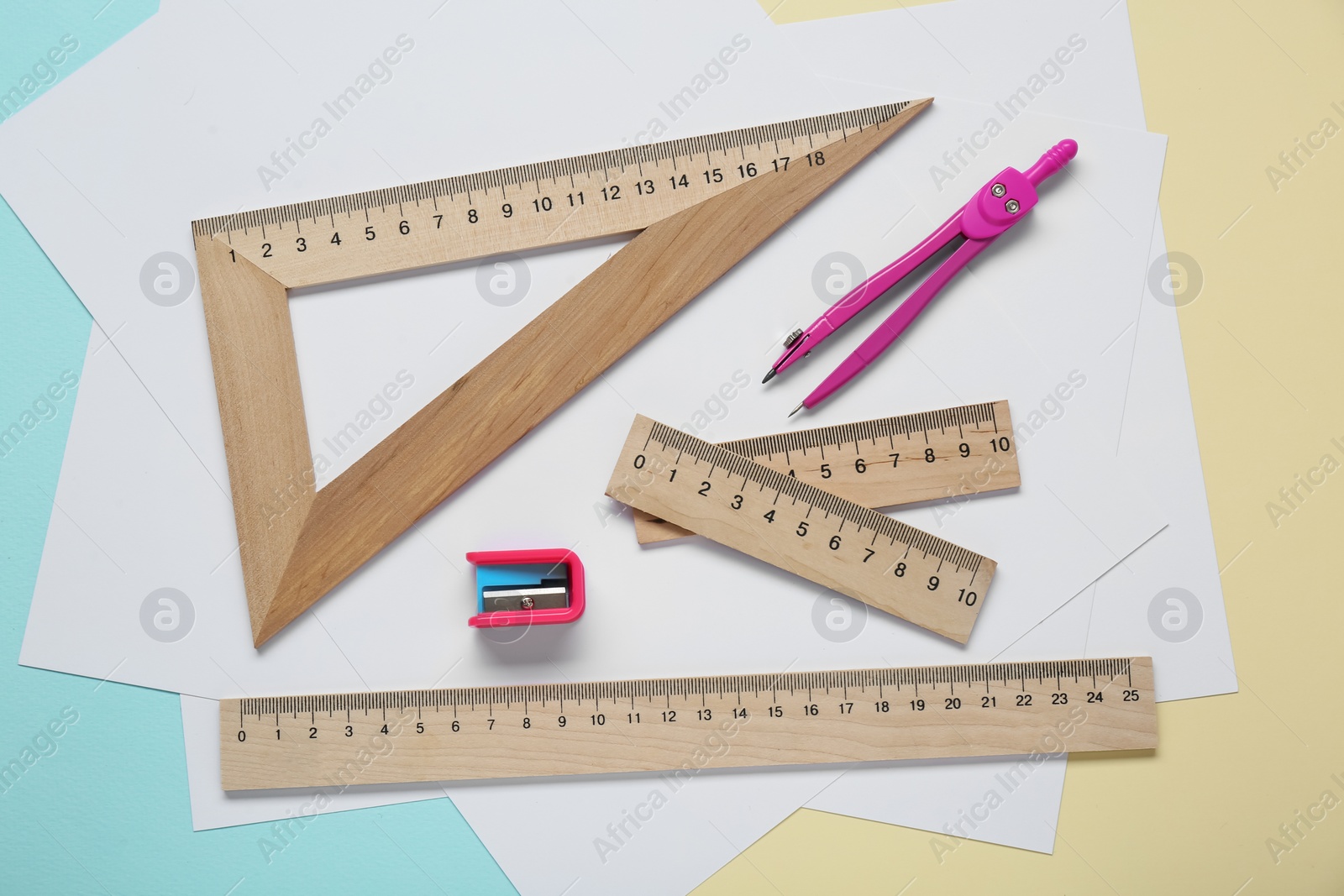 Photo of Different rulers and compass on color background, flat lay