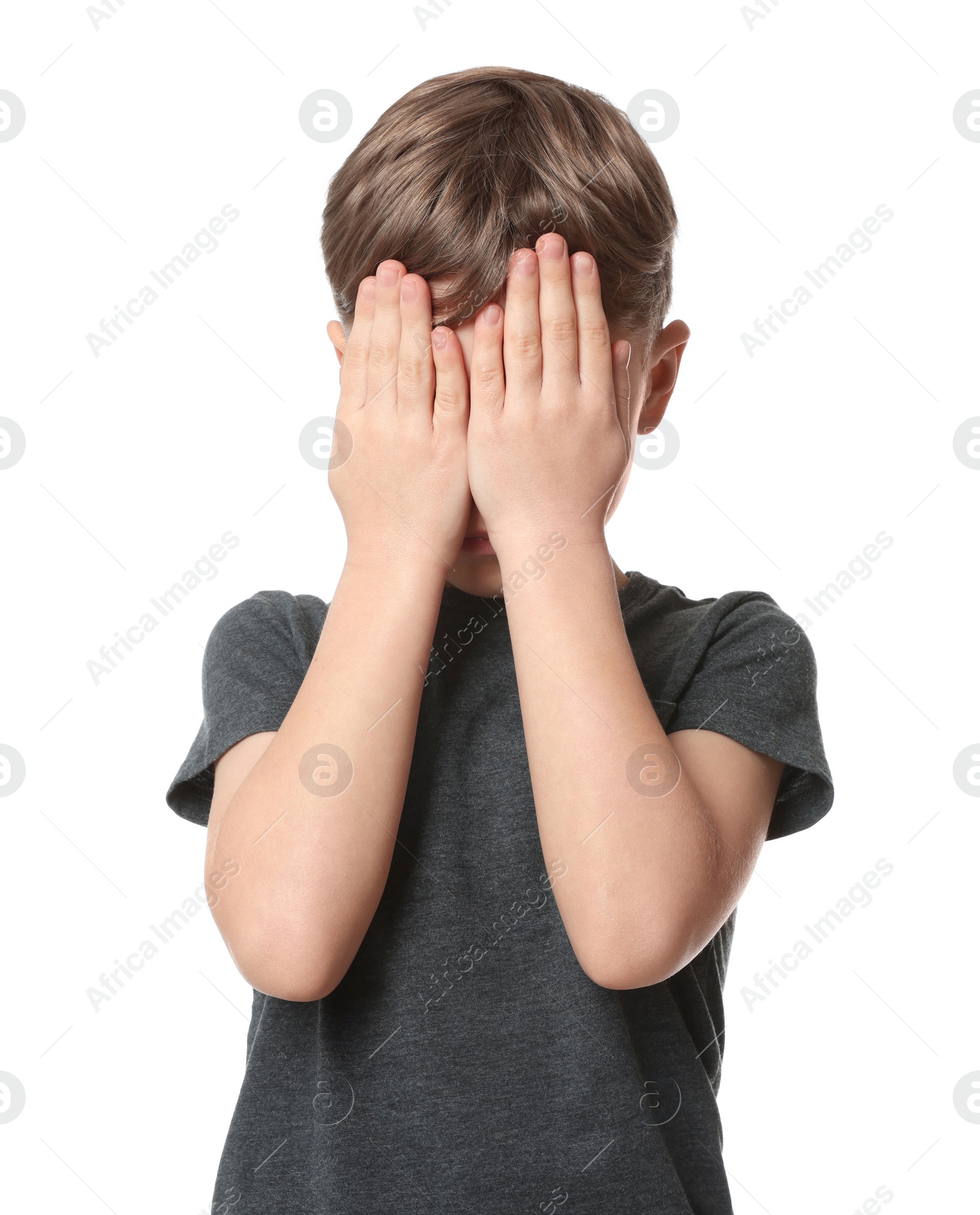 Photo of Boy covering face with hands on white background. Children's bullying