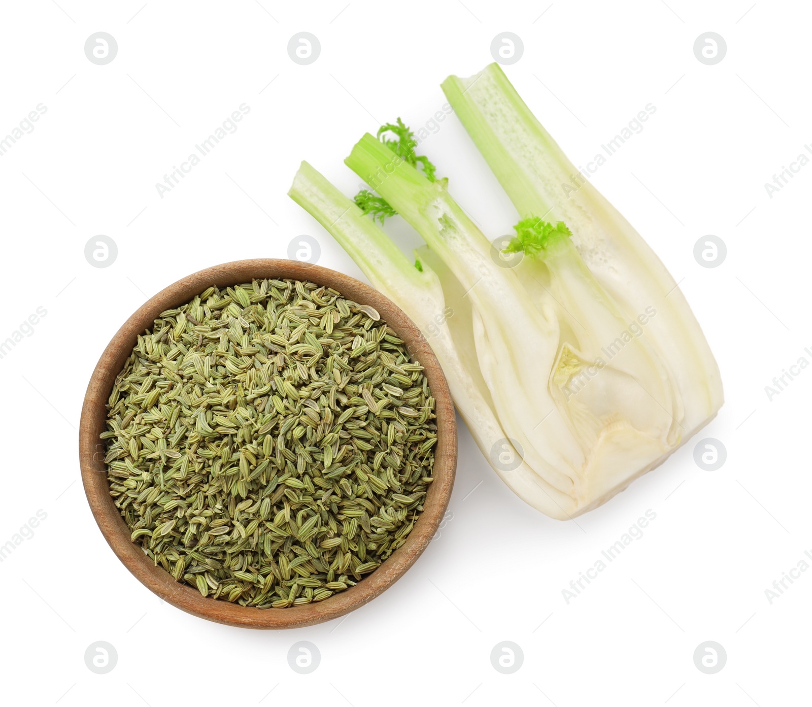 Photo of Cut fennel bulb and seeds in bowl isolated on white, top view