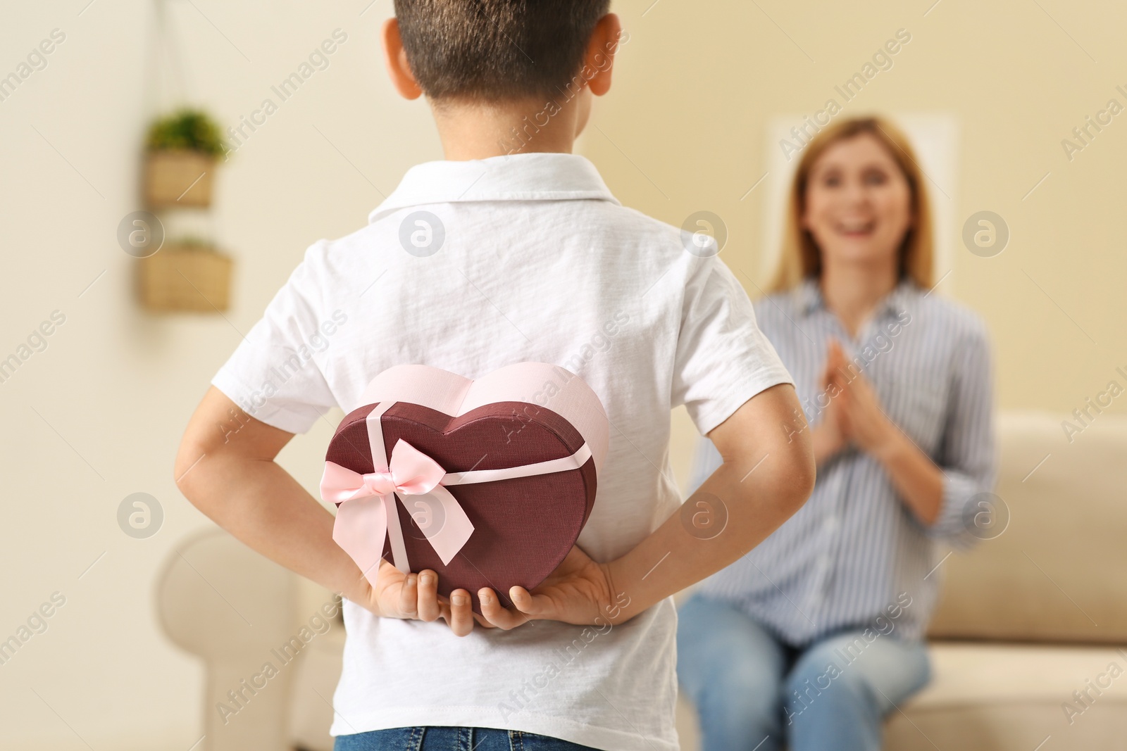 Photo of Little boy congratulating his mom at home. Happy Mother's Day
